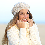 Woman smiling warmly clothed in winter